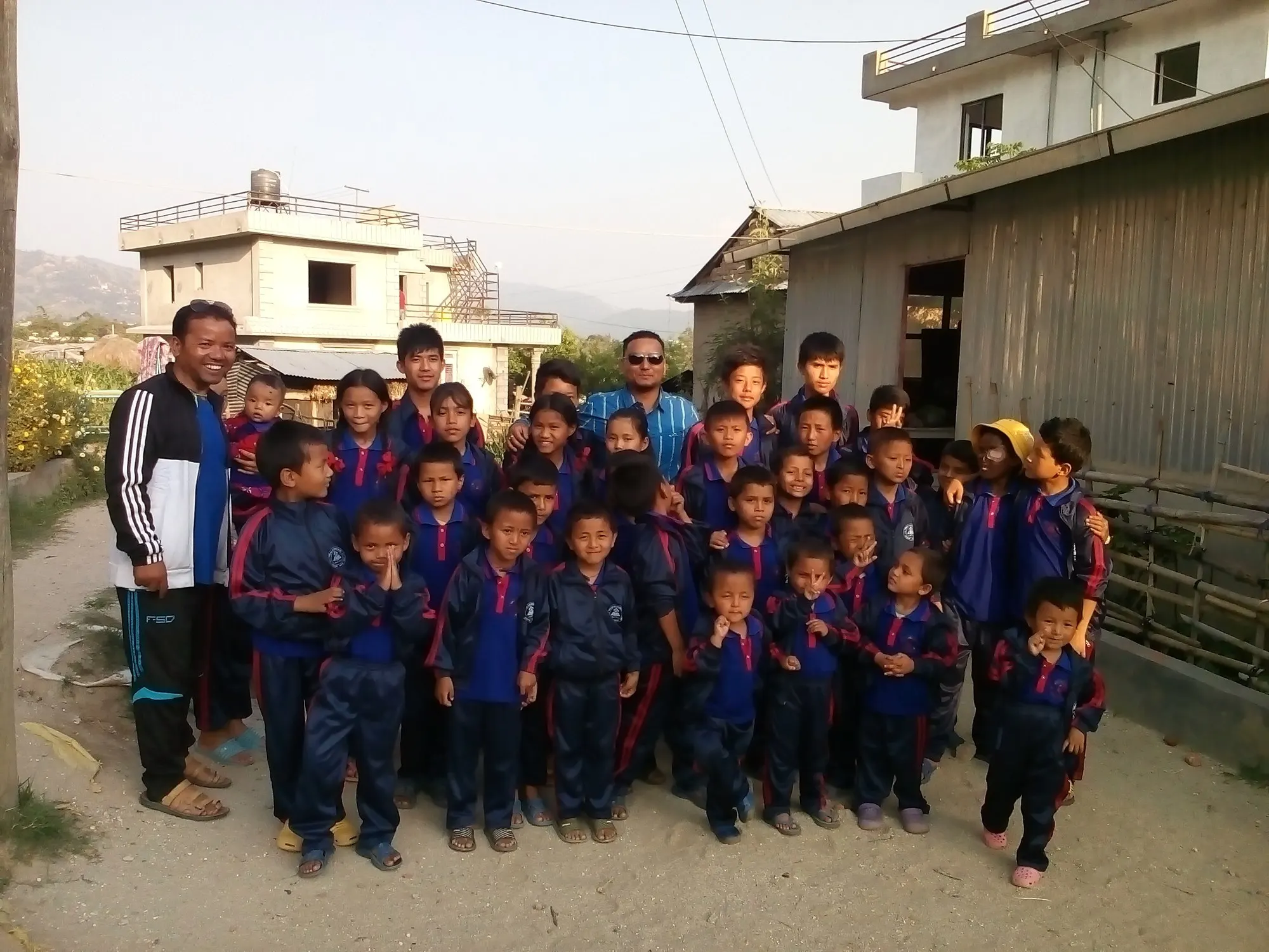 The children of the home standing together in the courtyard